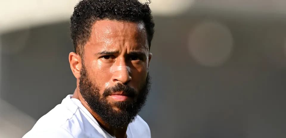 Player with beard and curly hair looking intently