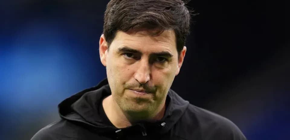 Coach in black jacket during match preparation