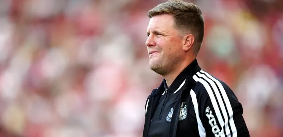 Men's football coach on sidelines during match