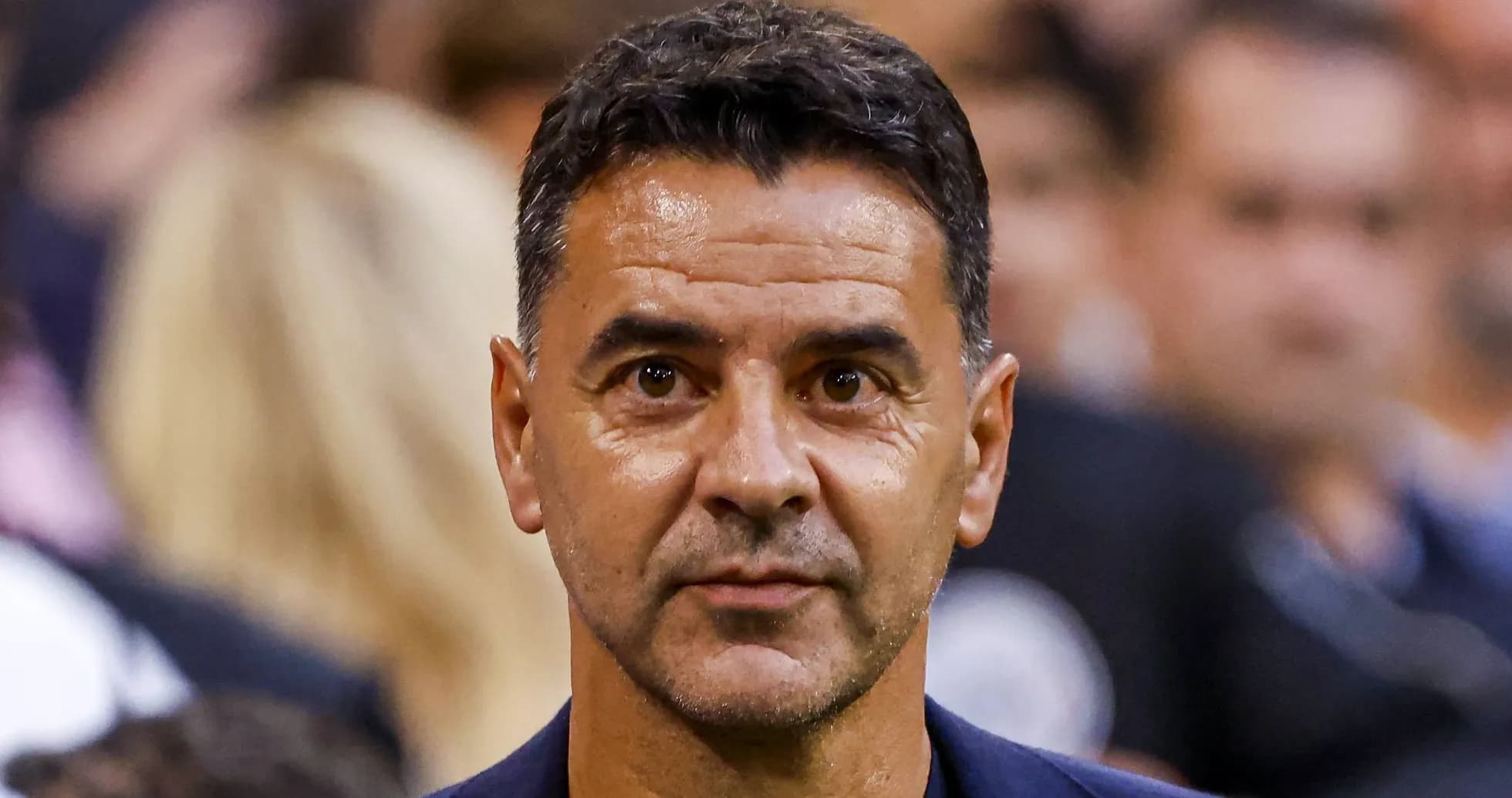 Football manager observing the match from sidelines