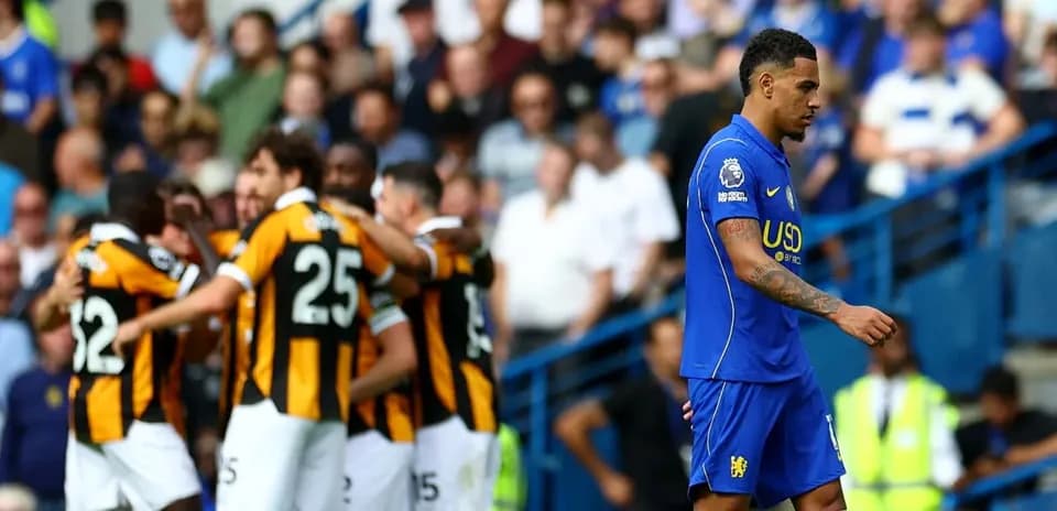 Player walking past celebrating teammates after goal