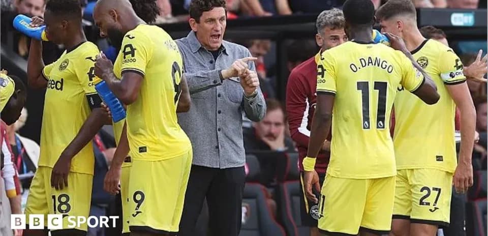 Brentford players and coach during a match break