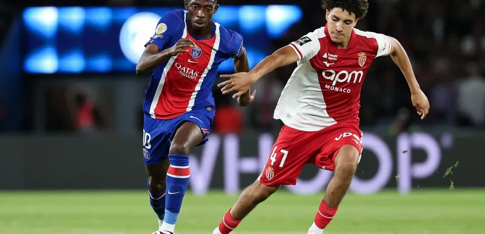 PSG player dribbling past Monaco defender during match
