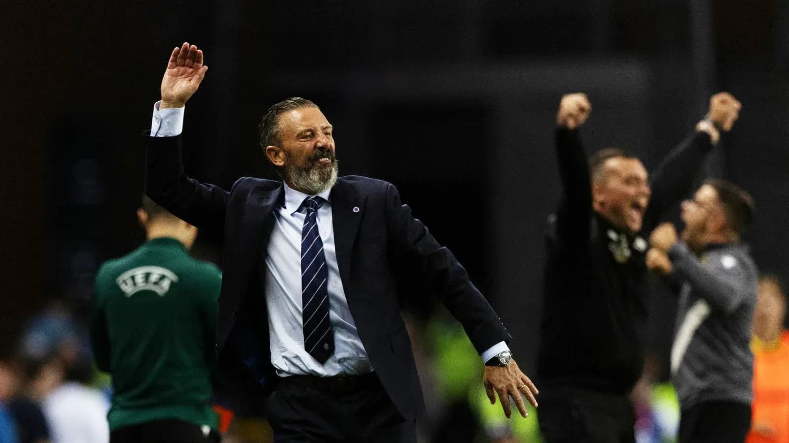 Coach celebrating with raised hand during match