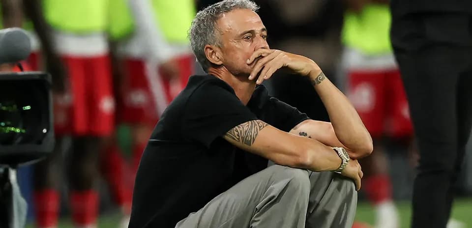 Coach sitting on the field during a match