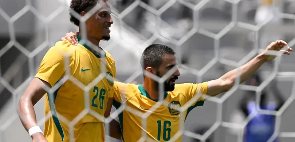 Two Australian players celebrating a goal