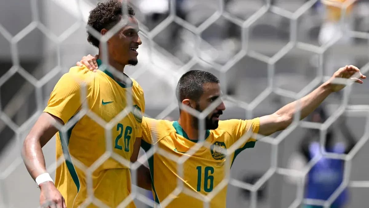 Two Australian players celebrating a goal