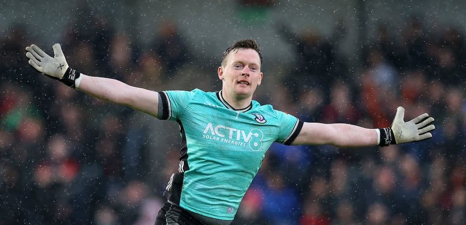 Goalkeeper celebrating during a match in rain