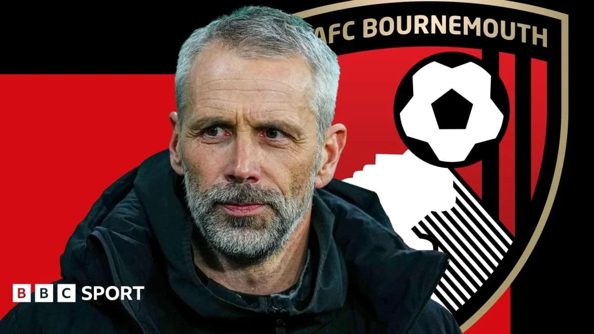 AFC Bournemouth manager in front of team logo