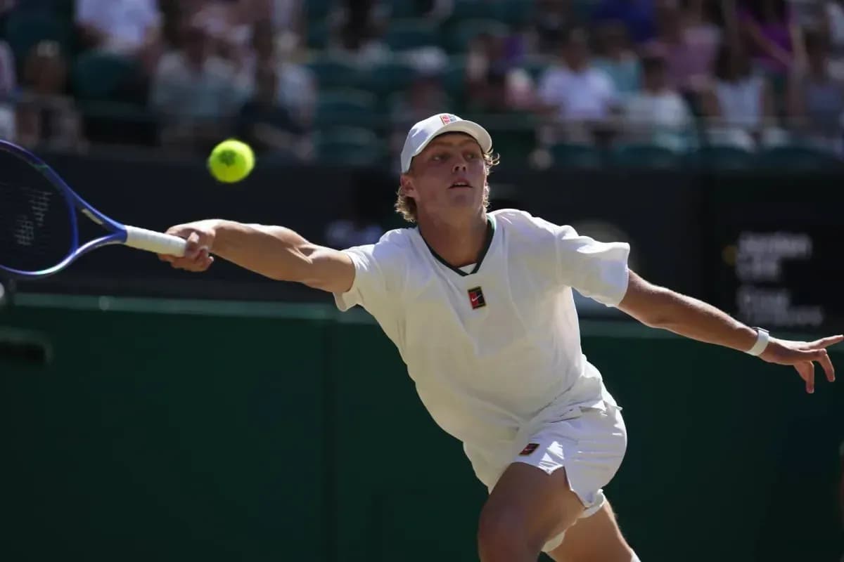 Tennis player reaching for a ball during match