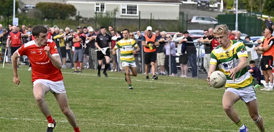 Player passing the ball during a Gaelic football match