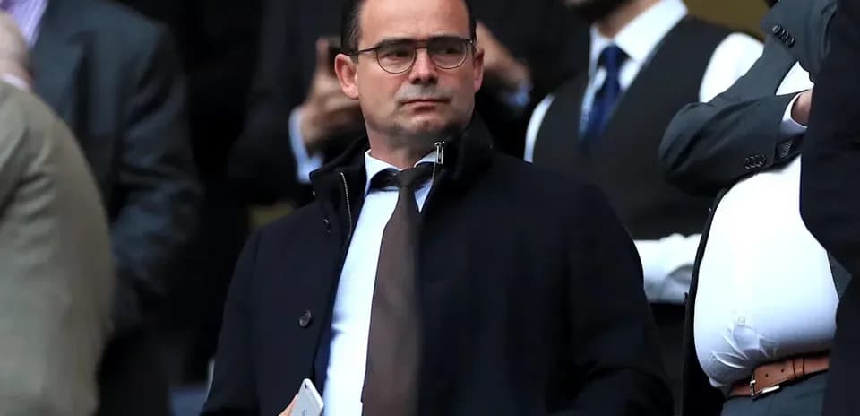 Man in suit observing from stadium stands