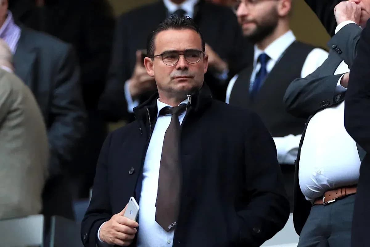 Man in suit observing from stadium stands