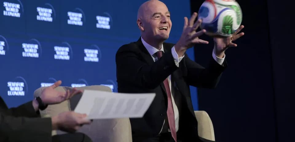 Official holding a soccer ball at event