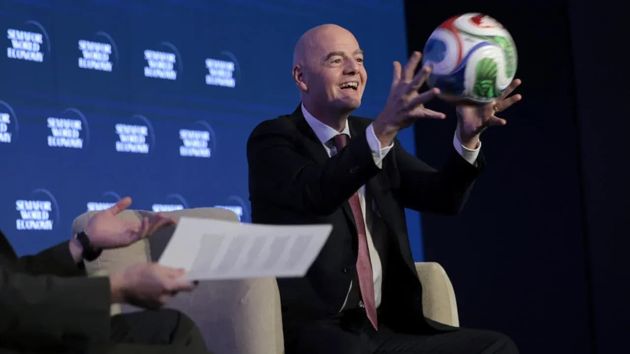 Official holding a soccer ball at event