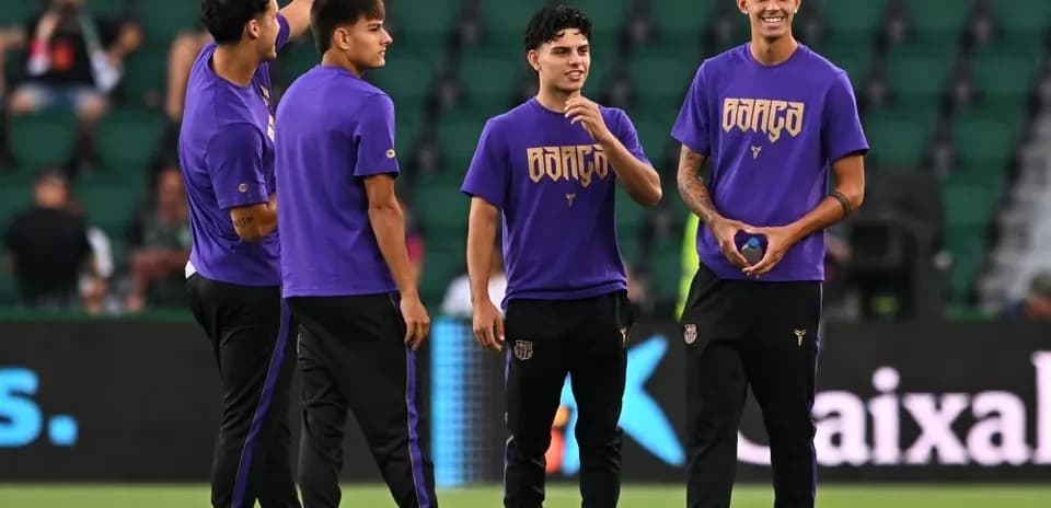 Players warming up on the field in purple shirts