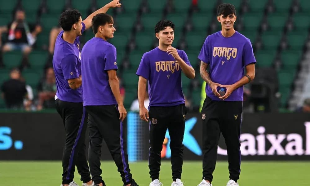 Players warming up on the field in purple shirts