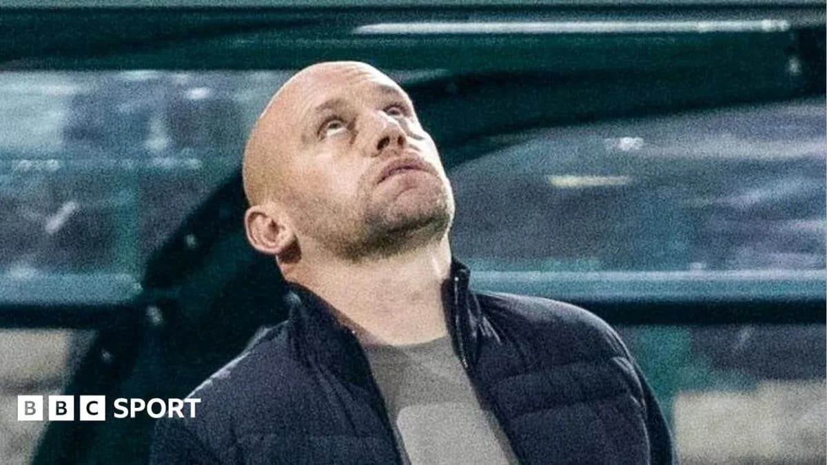 Coach looking up from the sidelines during match