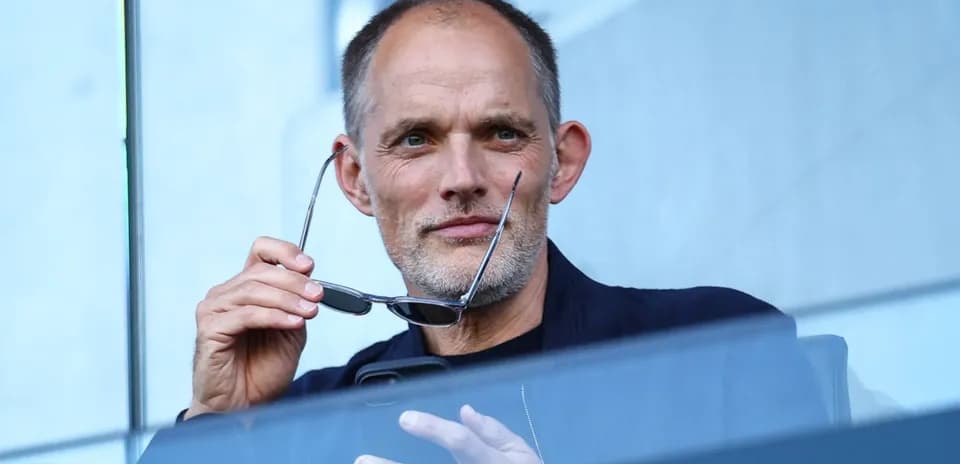 Man holding glasses while sitting in a stadium