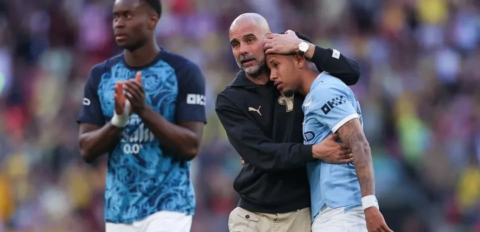 Pep Guardiola comforting player after the match