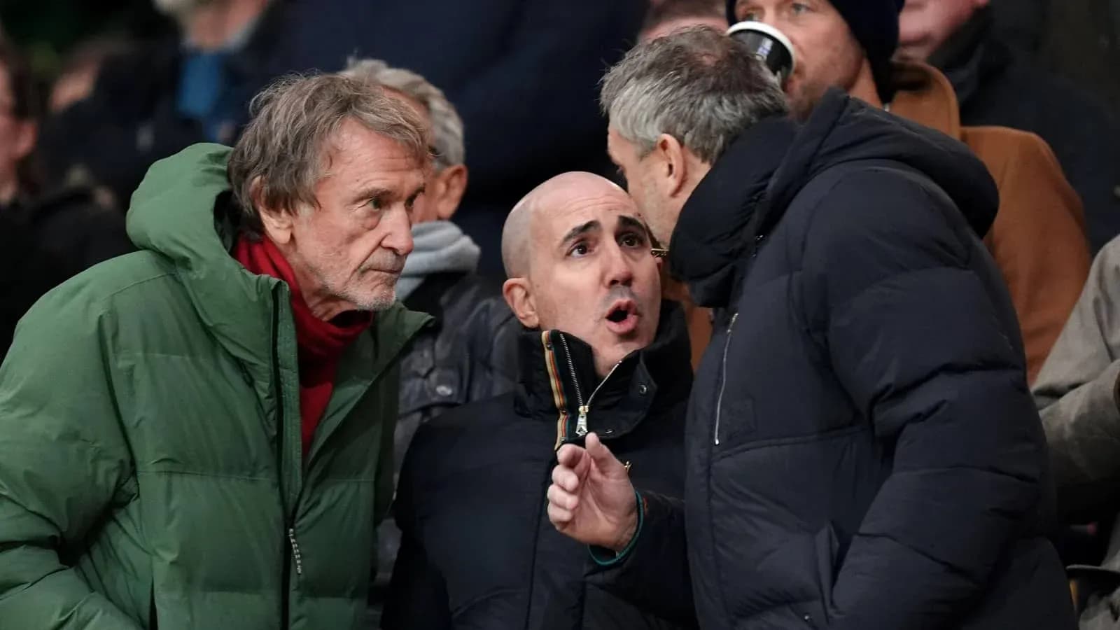 Three fans discussing during a football match