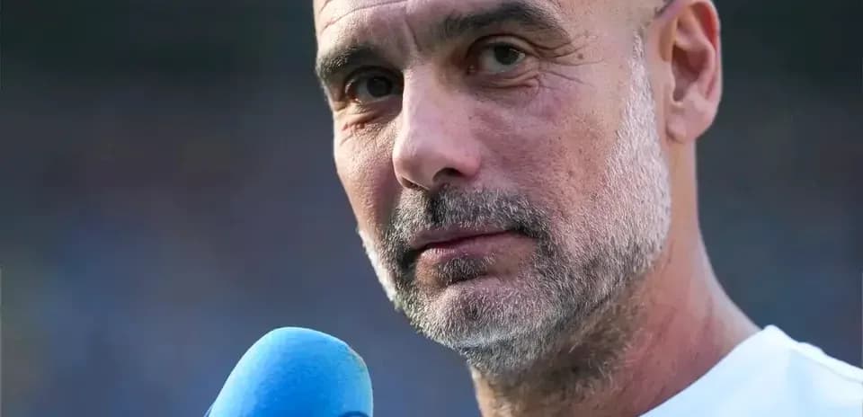 Men's football coach speaking into a microphone