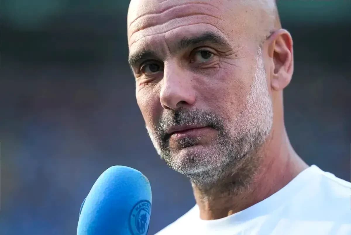 Men's football coach speaking into a microphone