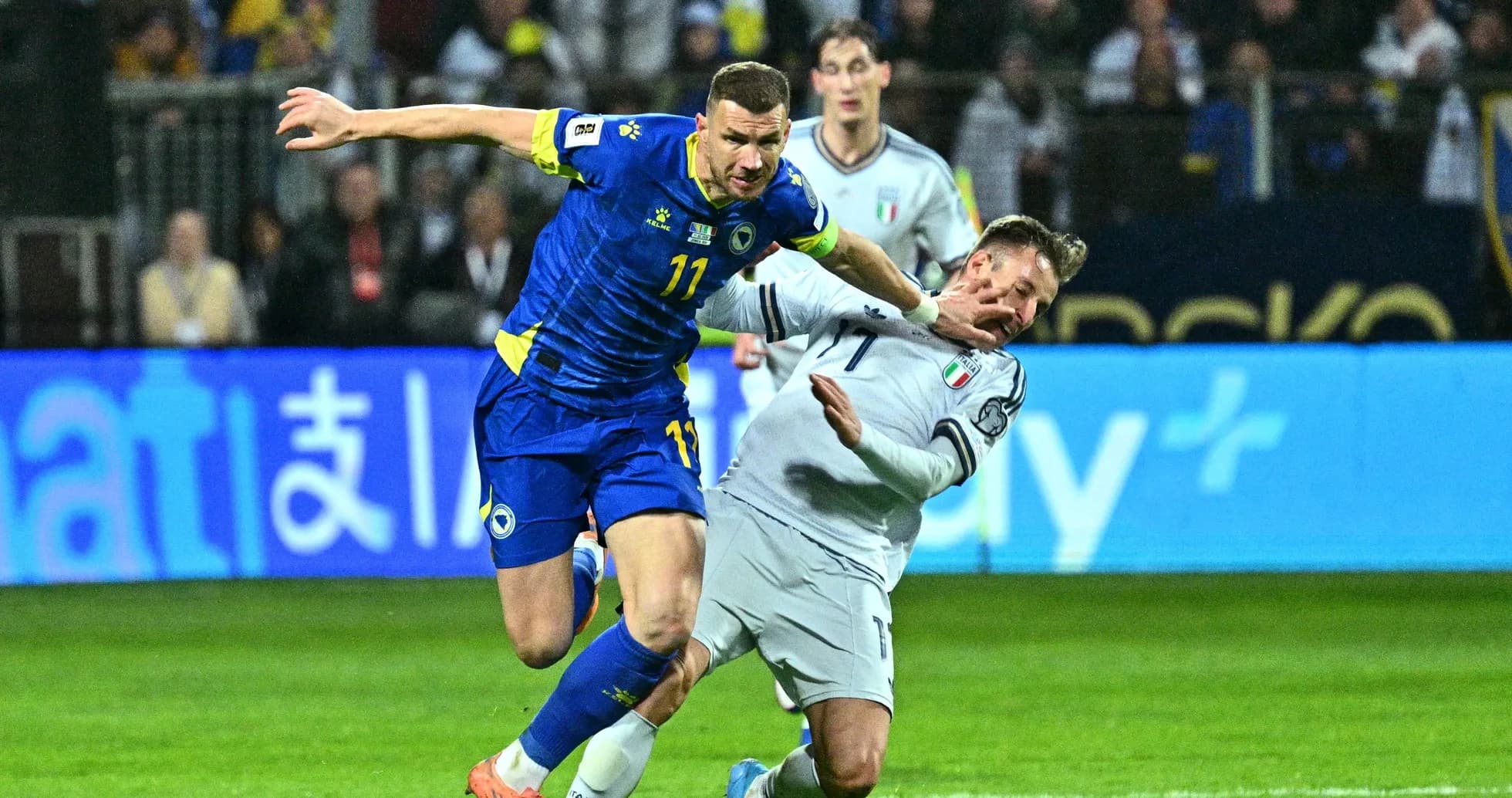 Bosnia player challenging Italy player during match
