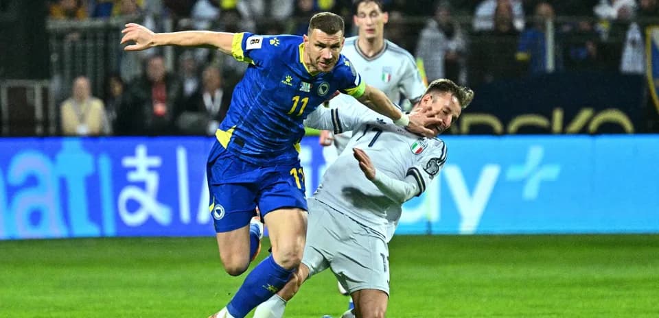 Bosnia player challenging Italy player during match