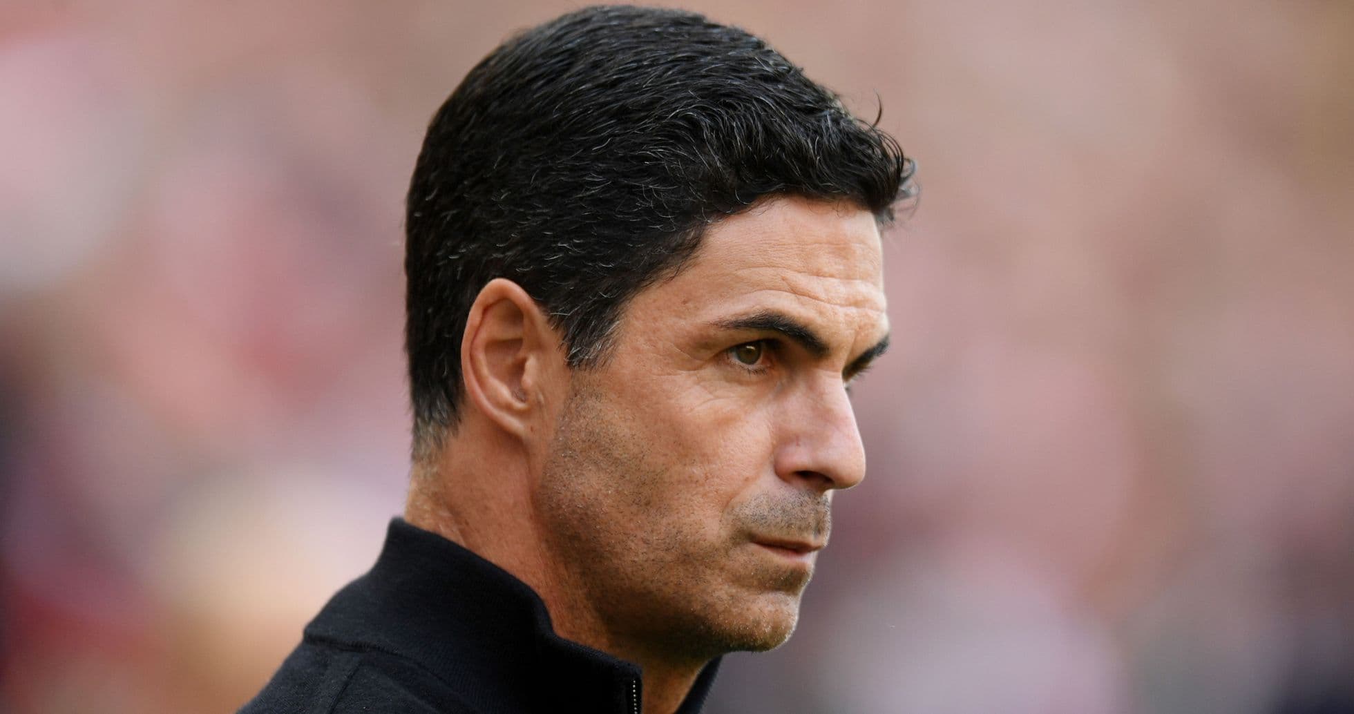 Football manager observing match from sidelines