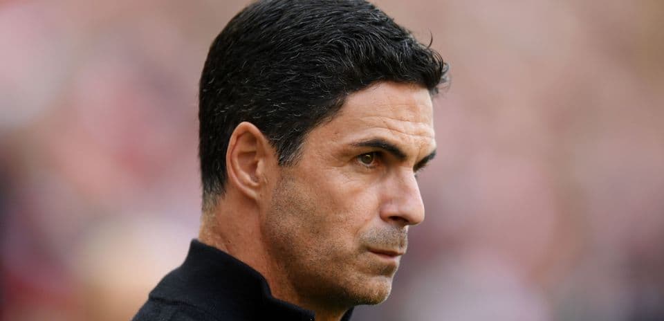 Football manager observing match from sidelines