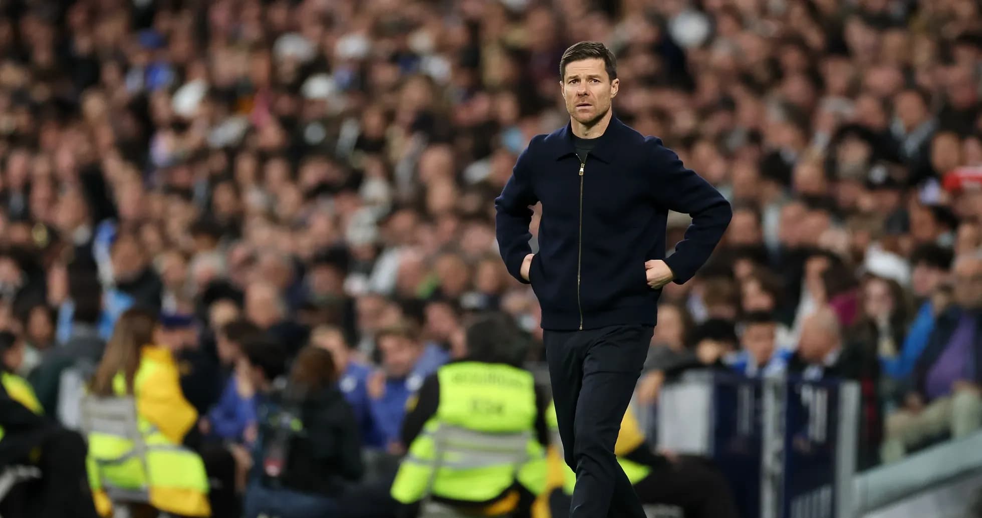 Coach walking along the sidelines during match