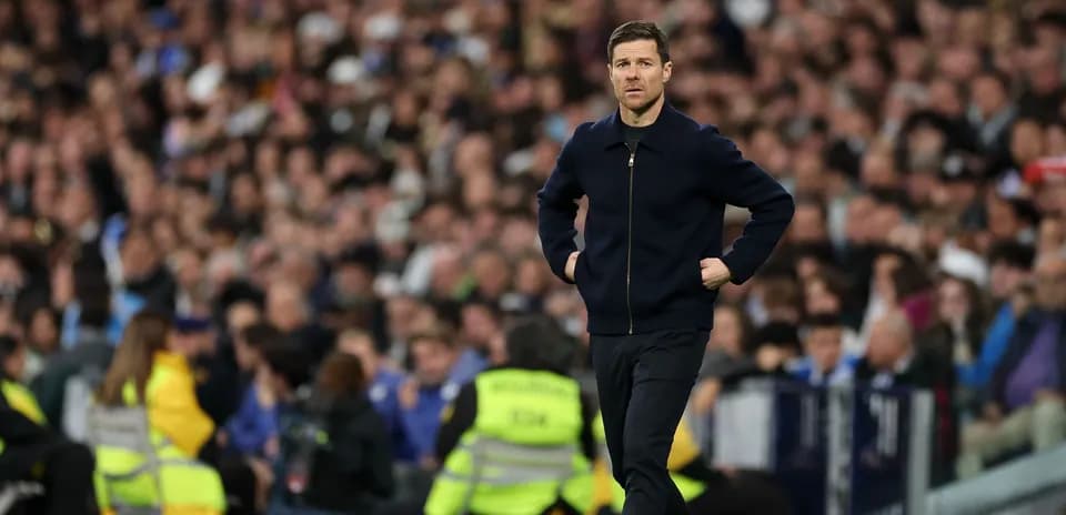 Coach walking along the sidelines during match