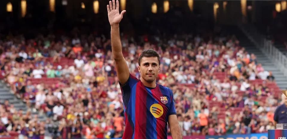 Rodrigo Hernández waving to fans at Camp Nou
