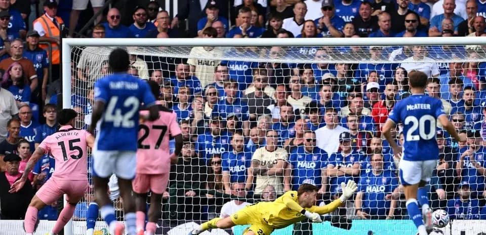 Goalkeeper diving as player takes penalty shot