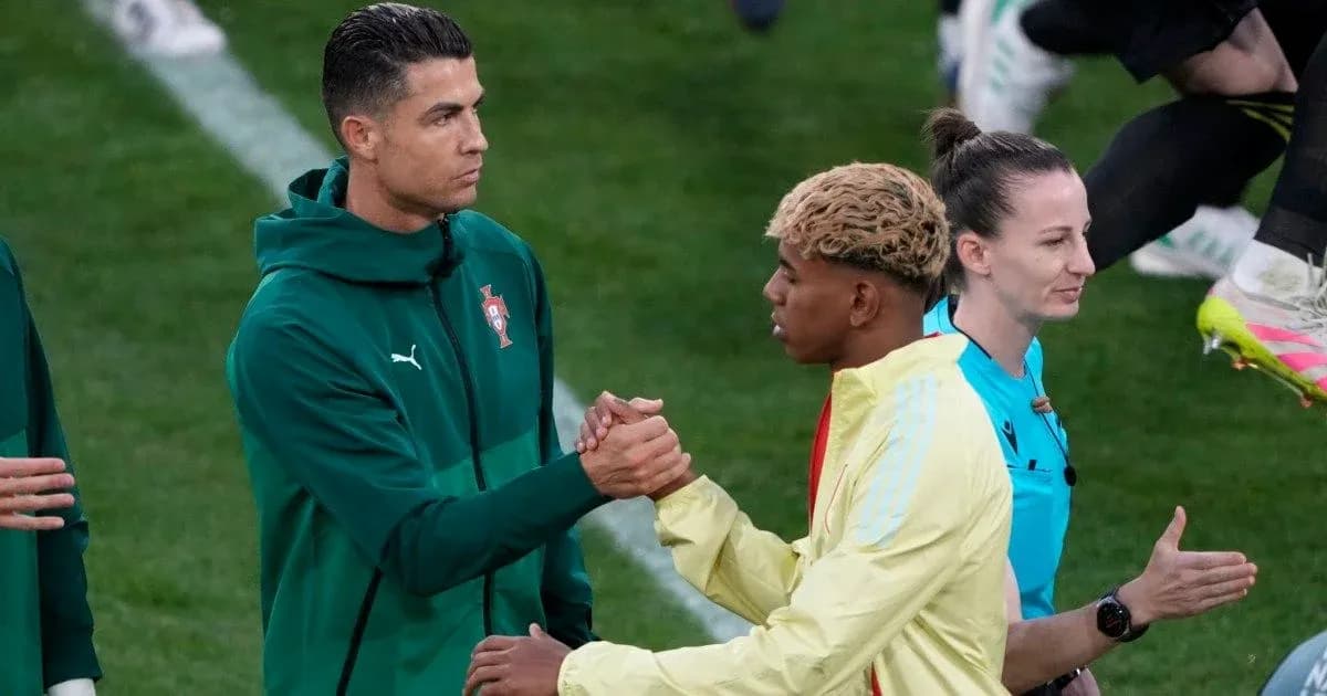 İki futbolçu əl sıxışır, hakem arxada durur