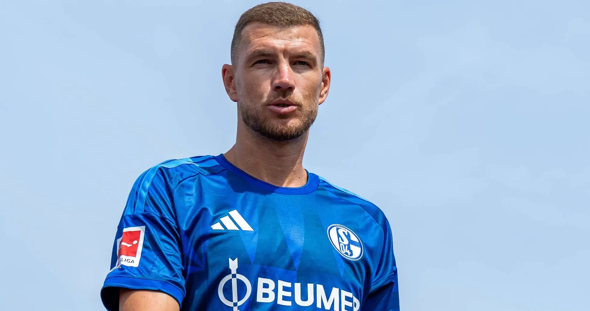 Futbolçu mavi forma ilə kameraya baxır