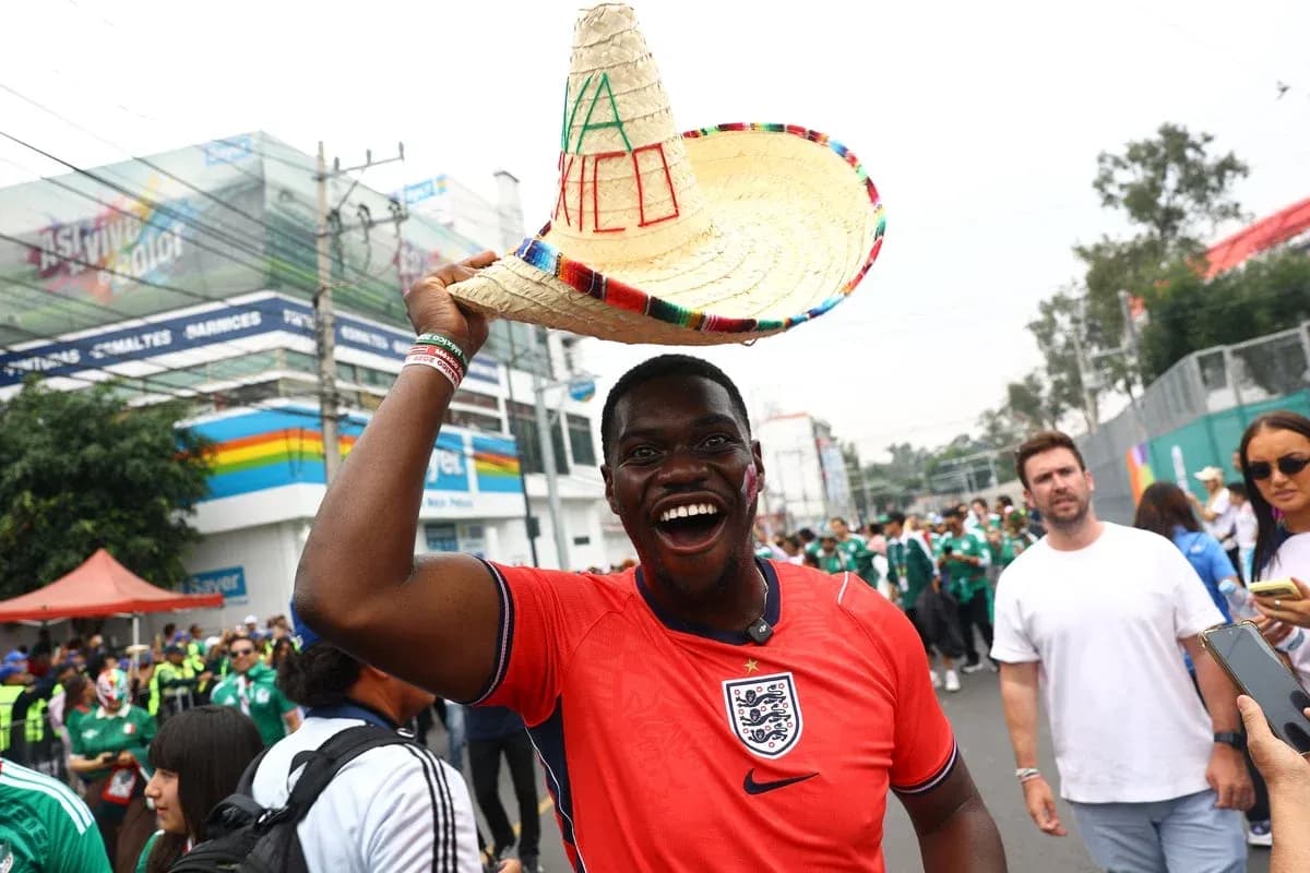 Fan in England jersey holding sombrero at event