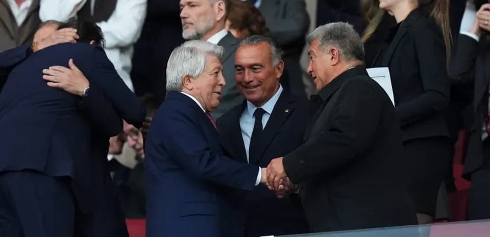 Four men shaking hands in stadium stands