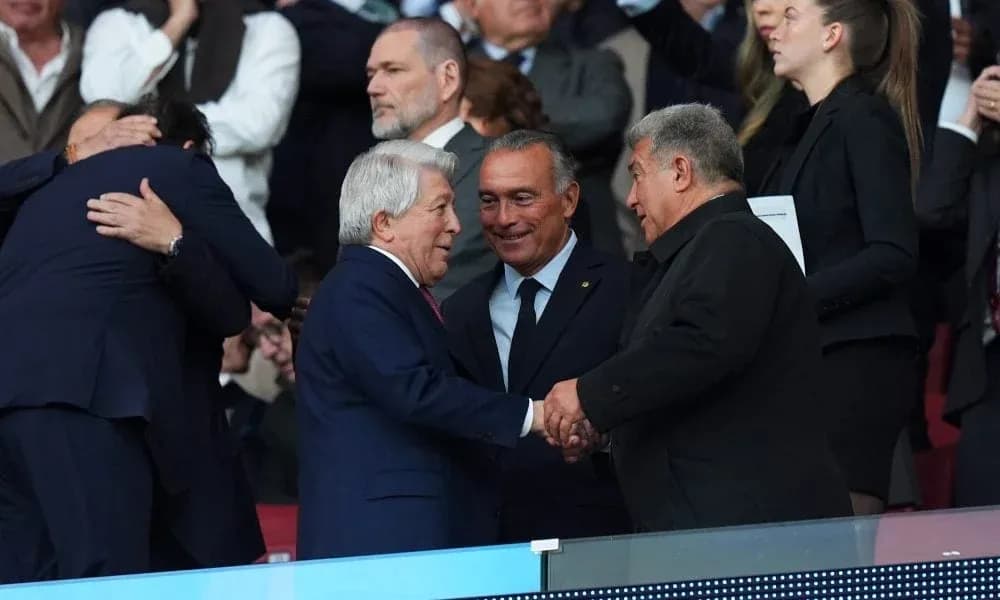 Four men shaking hands in stadium stands