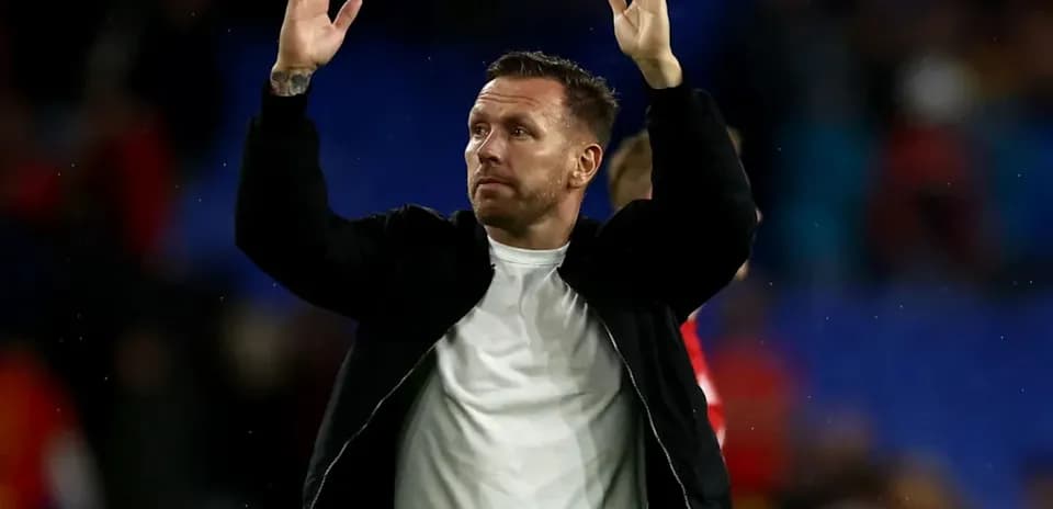Coach acknowledging fans after the match