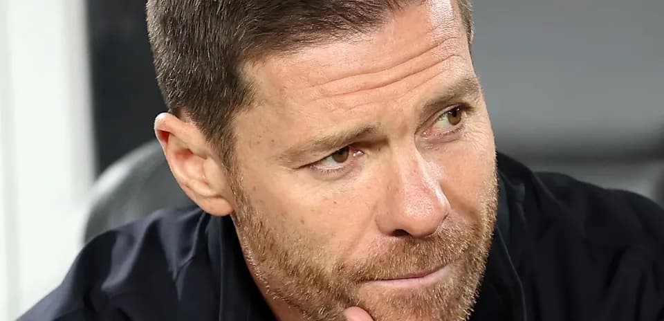 Football manager contemplating during match on bench