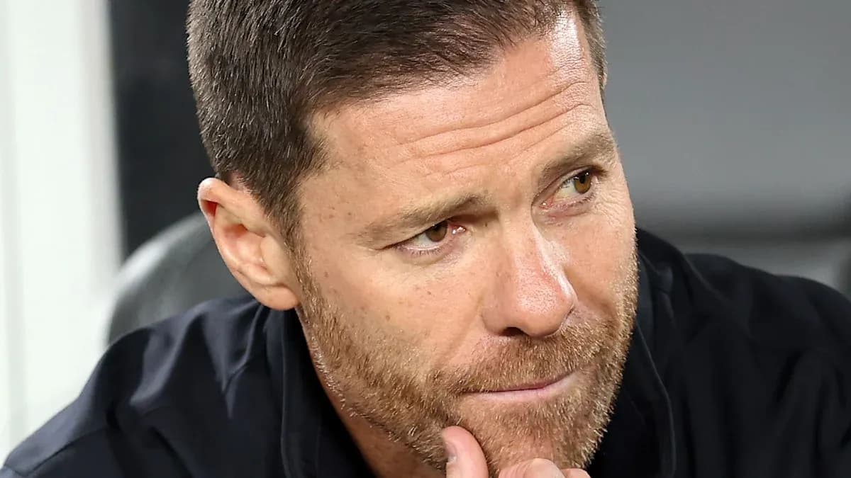 Football manager contemplating during match on bench