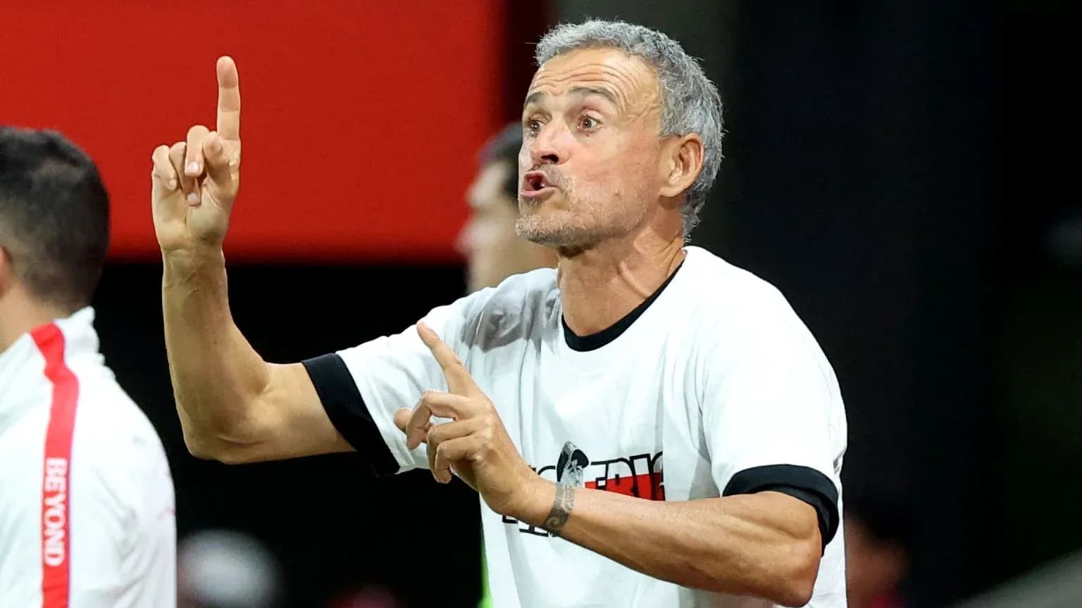 Coach giving instructions on the sidelines during match