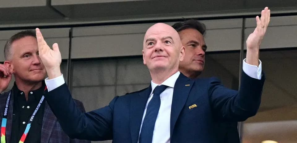 FIFA president gesturing in stadium box