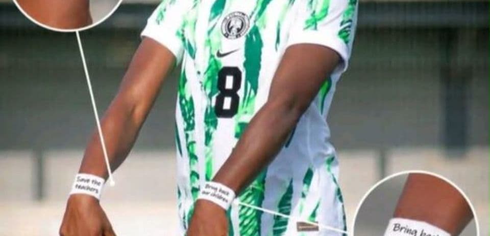 Football player displaying wristbands with messages