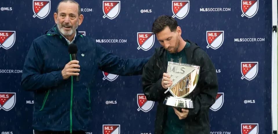 Lionel Messi holding MLS trophy during award ceremony