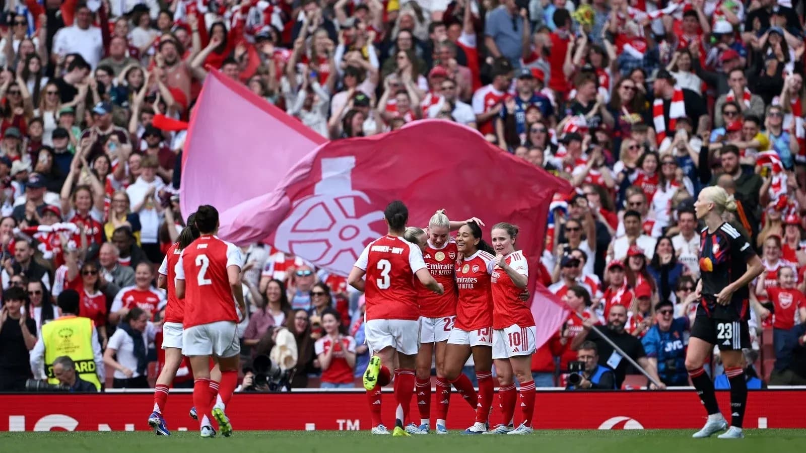 Arsenal women celebrating goal with fans in background