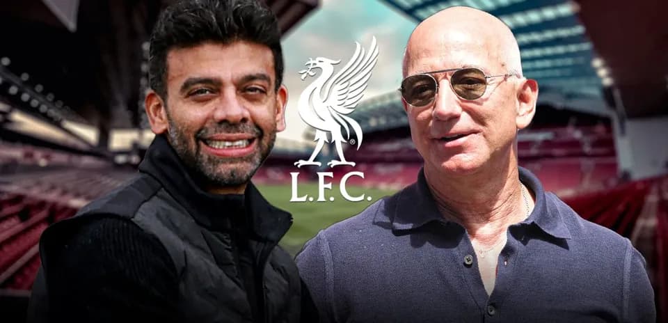 Two men in front of Liverpool FC stadium