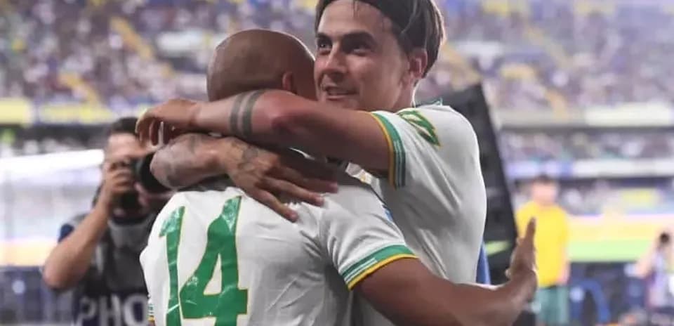 Players celebrating with an embrace after match